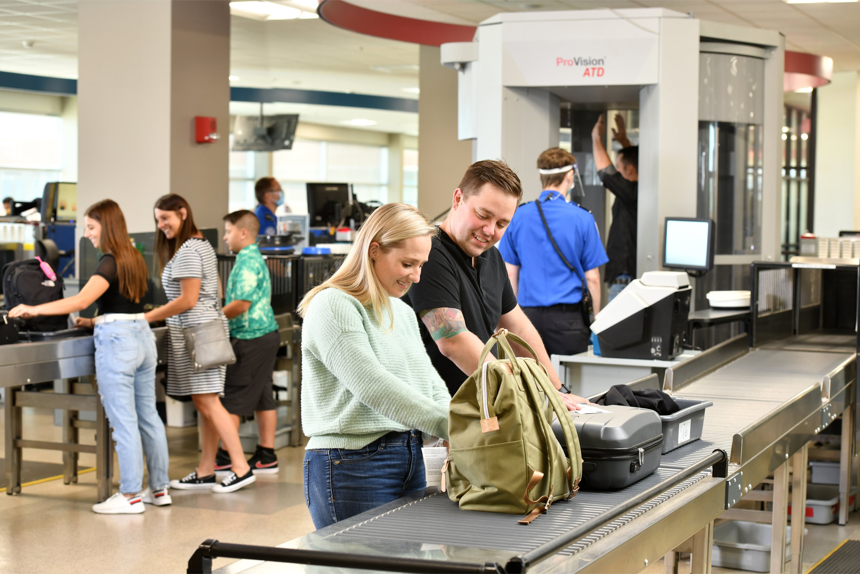 Couple going through TSA security at Des Moines International Airport